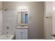 Bathroom featuring a vanity with granite countertop, white cabinets, and tiled shower at 4650 Big Valley Ct, Stone Mountain, GA 30083