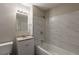 Bathroom features white tile, granite countertops, and updated fixtures at 4650 Big Valley Ct, Stone Mountain, GA 30083