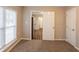 Bedroom featuring neutral walls and carpet with an open doorway to the kitchen at 4650 Big Valley Ct, Stone Mountain, GA 30083