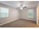 Cozy bedroom featuring plush carpeting, neutral walls, and ample natural light at 4650 Big Valley Ct, Stone Mountain, GA 30083