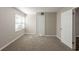 Bright bedroom with neutral walls, carpeted floor, closet, and natural light from a window at 4650 Big Valley Ct, Stone Mountain, GA 30083