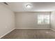 Bedroom with neutral carpet, gray walls and window with blinds at 4650 Big Valley Ct, Stone Mountain, GA 30083