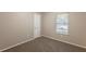 Bedroom with neutral carpet, gray walls, window with blinds, and a closet at 4650 Big Valley Ct, Stone Mountain, GA 30083