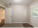 Carpeted bedroom featuring an exterior door and an interior door to bathroom at 4650 Big Valley Ct, Stone Mountain, GA 30083