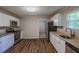 Well-lit kitchen featuring stainless steel appliances, granite countertops, and sleek white cabinetry at 4650 Big Valley Ct, Stone Mountain, GA 30083