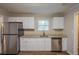 Functional kitchen featuring stainless steel appliances, granite countertops, and wooden floors at 4650 Big Valley Ct, Stone Mountain, GA 30083