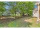 Home featuring mature landscaping, green grass, and views of the building at 484 Cathedral Dr, Mcdonough, GA 30253