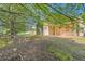 Backyard features mature trees, green grass, and a view of the back of the home at 484 Cathedral Dr, Mcdonough, GA 30253