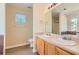 Bathroom featuring double sink vanity, laminate floors, tub and shower combo, and a window at 484 Cathedral Dr, Mcdonough, GA 30253