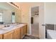 Bathroom with double sink vanity, soaking tub, and doorways to bedroom and hall at 484 Cathedral Dr, Mcdonough, GA 30253