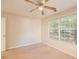 This bedroom has neutral walls, carpet, and a window overlooking the yard at 484 Cathedral Dr, Mcdonough, GA 30253