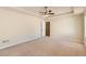 Spacious bedroom featuring neutral color palette, carpet, ceiling fan, and access door at 484 Cathedral Dr, Mcdonough, GA 30253