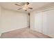 This bedroom has neutral walls, carpet, a window, and a closet with bi-fold doors at 484 Cathedral Dr, Mcdonough, GA 30253