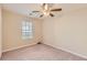 This bedroom has neutral walls, carpet, and a window with blinds at 484 Cathedral Dr, Mcdonough, GA 30253