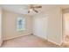 This cozy bedroom has carpet, ceiling fan, a double closet and a window overlooking the yard at 484 Cathedral Dr, Mcdonough, GA 30253