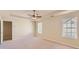 Bright and airy bedroom features neutral walls, carpet, ceiling fan, and double windows at 484 Cathedral Dr, Mcdonough, GA 30253