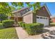 Charming brick and stone home with manicured bushes and a well-maintained lawn at 484 Cathedral Dr, Mcdonough, GA 30253