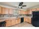 Efficient kitchen design with lots of wood cabinets, and tile backsplash at 484 Cathedral Dr, Mcdonough, GA 30253