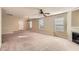 Large living room with a fireplace, big windows, and neutral carpeting at 484 Cathedral Dr, Mcdonough, GA 30253