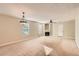 Bright living area with a fireplace, big windows, and neutral carpeting at 484 Cathedral Dr, Mcdonough, GA 30253