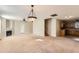 Open concept living area with fireplace, ceiling fan, and a view of kitchen at 484 Cathedral Dr, Mcdonough, GA 30253