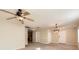 Spacious living room featuring a ceiling fan and an open doorway to the kitchen at 484 Cathedral Dr, Mcdonough, GA 30253