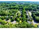 Aerial view of the property nestled among mature trees in a residential neighborhood at 850 Old Spring Way, Sugar Hill, GA 30518