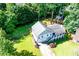 An aerial view shows the home's large yard, mature trees, and covered front porch at 850 Old Spring Way, Sugar Hill, GA 30518