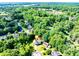 Aerial view of the home surrounded by lush greenery and mature trees in a quiet neighborhood at 850 Old Spring Way, Sugar Hill, GA 30518