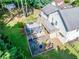 Aerial view of backyard with a large deck, hot tub, stone patio, and lush green landscaping at 850 Old Spring Way, Sugar Hill, GA 30518