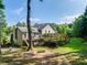 Backyard featuring a spacious wooden deck with multiple levels and well-maintained landscaping at 850 Old Spring Way, Sugar Hill, GA 30518