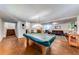 Large finished basement with pool table, lounge area, and access to the lower level stairs at 850 Old Spring Way, Sugar Hill, GA 30518