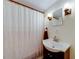 Bathroom with a pedestal sink, decorative lights, shower with curtain and stylish accents at 850 Old Spring Way, Sugar Hill, GA 30518