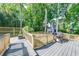Large deck with a grill, seating, and fenced in yard at 850 Old Spring Way, Sugar Hill, GA 30518