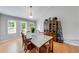 The dining room has hardwood floors, a modern light fixture, and backyard views at 850 Old Spring Way, Sugar Hill, GA 30518
