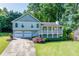 Charming two-story home featuring a covered front porch and a two-car garage at 850 Old Spring Way, Sugar Hill, GA 30518