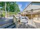 Raised hot tub with steps and surrounding deck space at 850 Old Spring Way, Sugar Hill, GA 30518