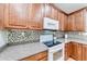 Close-up of a kitchen with white appliances and tiled backsplash at 850 Old Spring Way, Sugar Hill, GA 30518