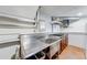 Basement kitchenette with stainless steel sink and dark wood cabinets at 850 Old Spring Way, Sugar Hill, GA 30518