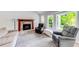 Bright living room featuring a stone fireplace, large windows, and comfortable seating at 850 Old Spring Way, Sugar Hill, GA 30518