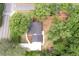 An aerial perspective displays a home with a metal roof, positioned on a corner lot with mature trees at 550 Stewart Nw Ave, Marietta, GA 30064
