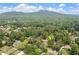 A distant aerial view captures a neighborhood surrounded by lush greenery, with a clear view of the nearby mountains at 550 Stewart Nw Ave, Marietta, GA 30064