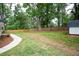 A newly landscaped backyard features a smooth walkway, well-kept lawn, and mature trees at 550 Stewart Nw Ave, Marietta, GA 30064