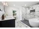 Bright bathroom with marble tile, a sleek bathtub, and double mirrors at 550 Stewart Nw Ave, Marietta, GA 30064