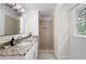 Bathroom with granite countertop vanity and tile shower at 550 Stewart Nw Ave, Marietta, GA 30064