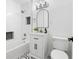 Bright bathroom featuring subway tile, a bathtub, and black hexagon tiled floors at 550 Stewart Nw Ave, Marietta, GA 30064