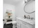 Well-lit powder room featuring a marble countertop, black hexagon floor tiles, and modern fixtures at 550 Stewart Nw Ave, Marietta, GA 30064