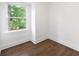 Bright and minimalist bedroom with hardwood floors and a large window offering views of the neighborhood at 550 Stewart Nw Ave, Marietta, GA 30064