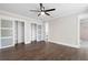 Bedroom with hardwood floors, modern ceiling fan, and frosted glass closet doors that complement the neutral walls at 550 Stewart Nw Ave, Marietta, GA 30064