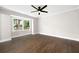 Bright and airy bedroom with hardwood floors, large windows offering scenic outdoor views, and a modern ceiling fan at 550 Stewart Nw Ave, Marietta, GA 30064